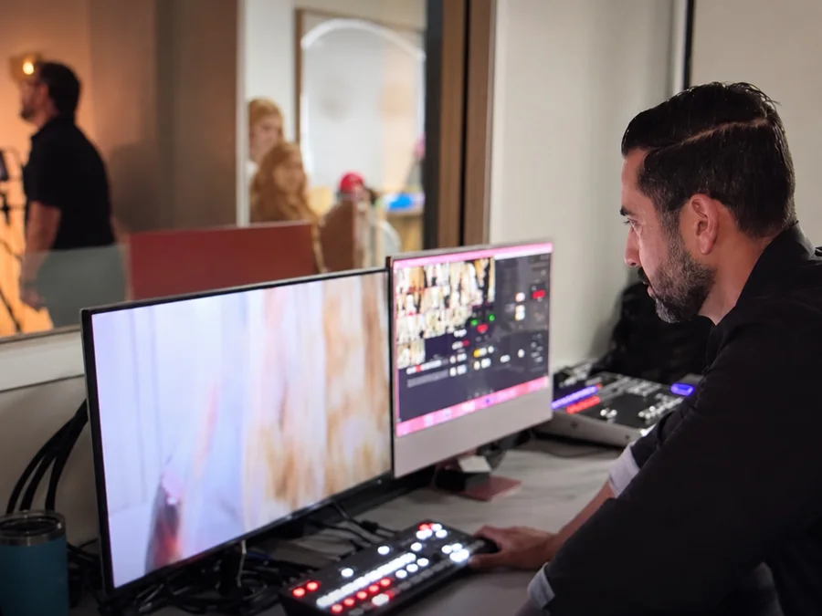 Tony Carrasco on the switcher while the podcast films behind the glass