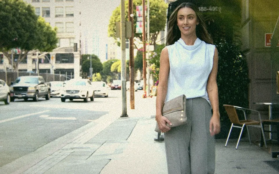 A woman carrying a Hammitt clutch
